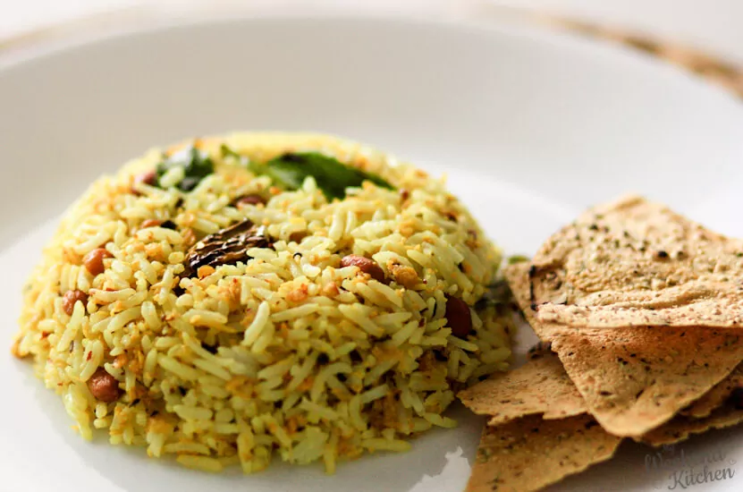 Mango Rice in a serving Plate with Papad As a Side Dish
