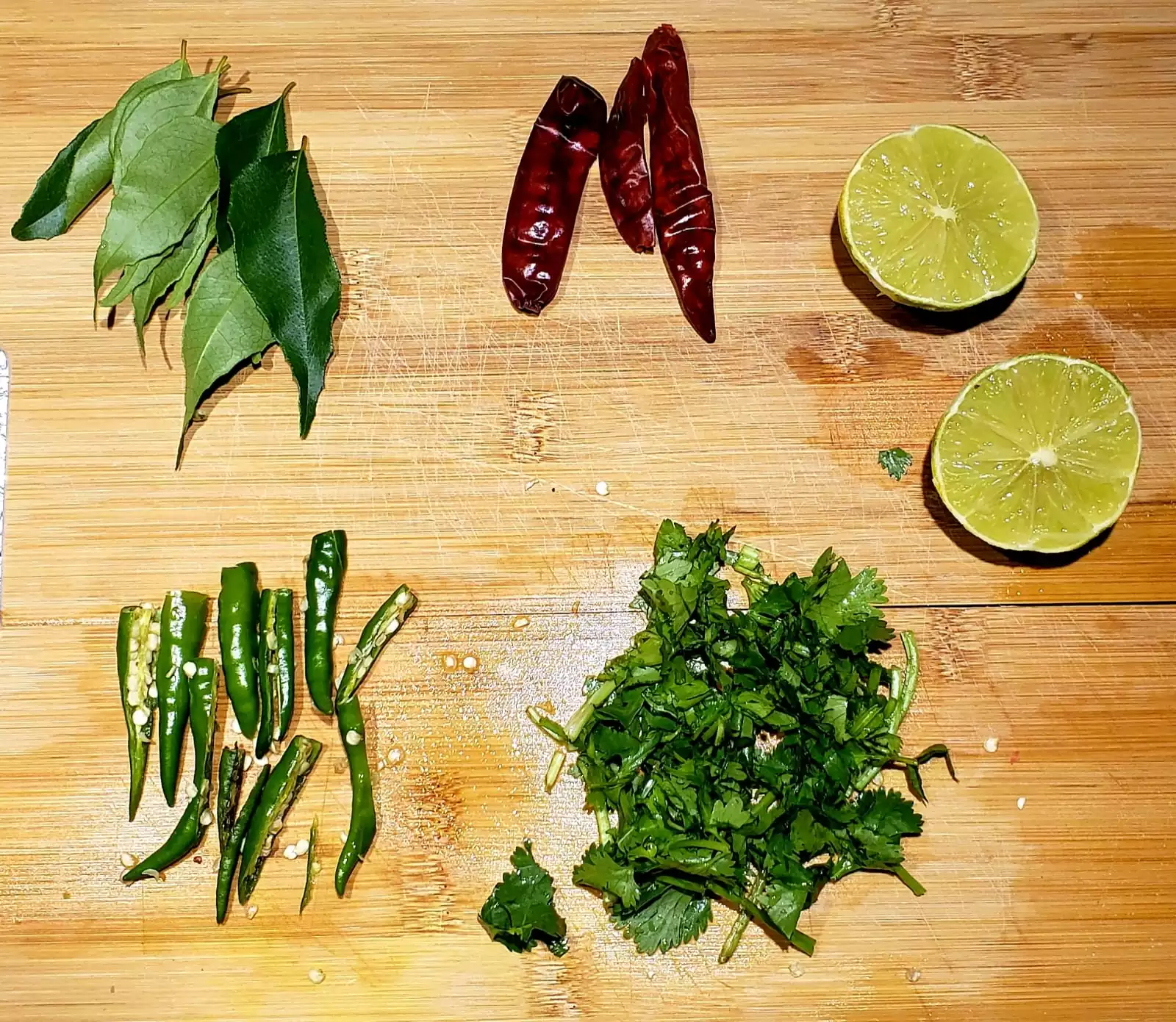 Ingredients for tampering: Curry leaves, red chillie, lemon slices, chopped cilantro & green chillies
