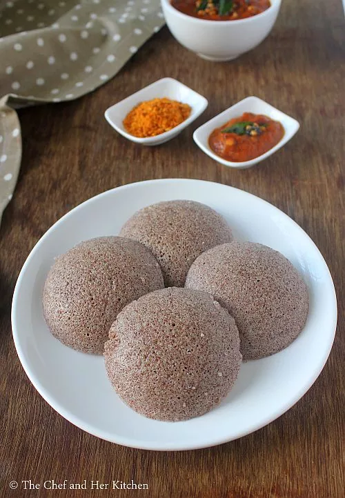 Finger Miller Idly served in a plate with Tomato Chutney and peanut powder